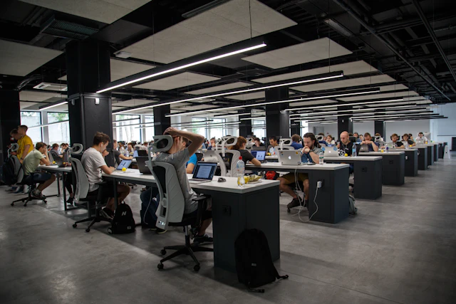 Technology professionals working at computers in a shared office