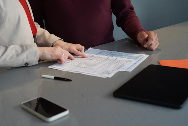 Professionals reviewing financial paperwork together