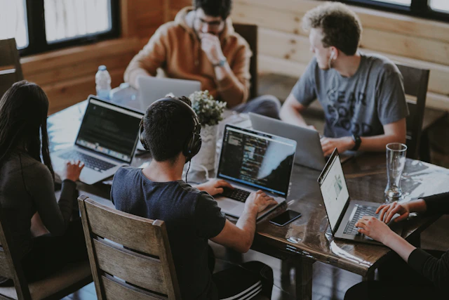 Colleagues working together at a shared desk