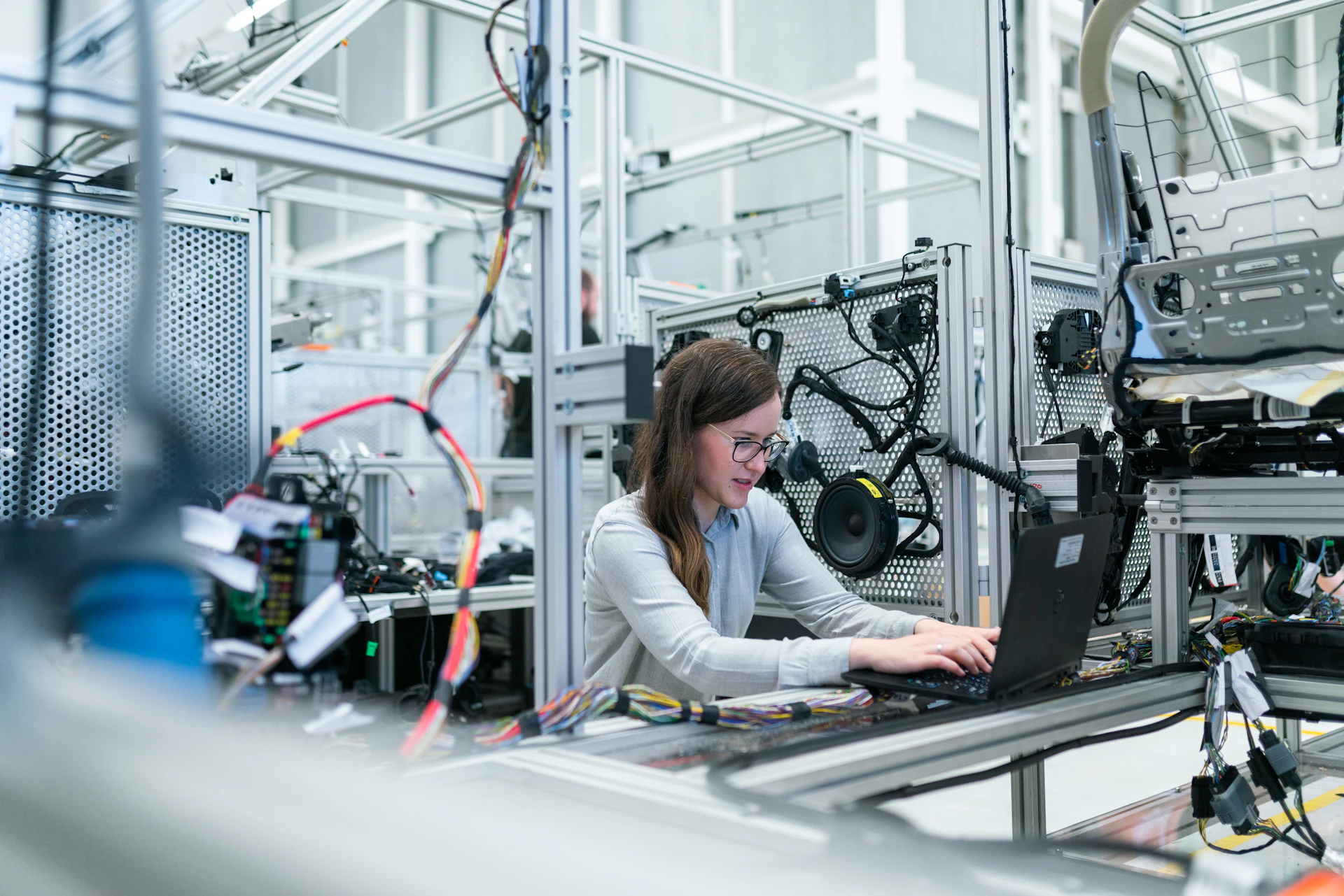 Electronics engineer using a laptop to run vehicle tests