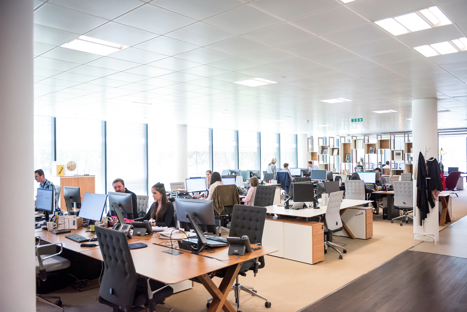 Service professionals working at desks in an open office