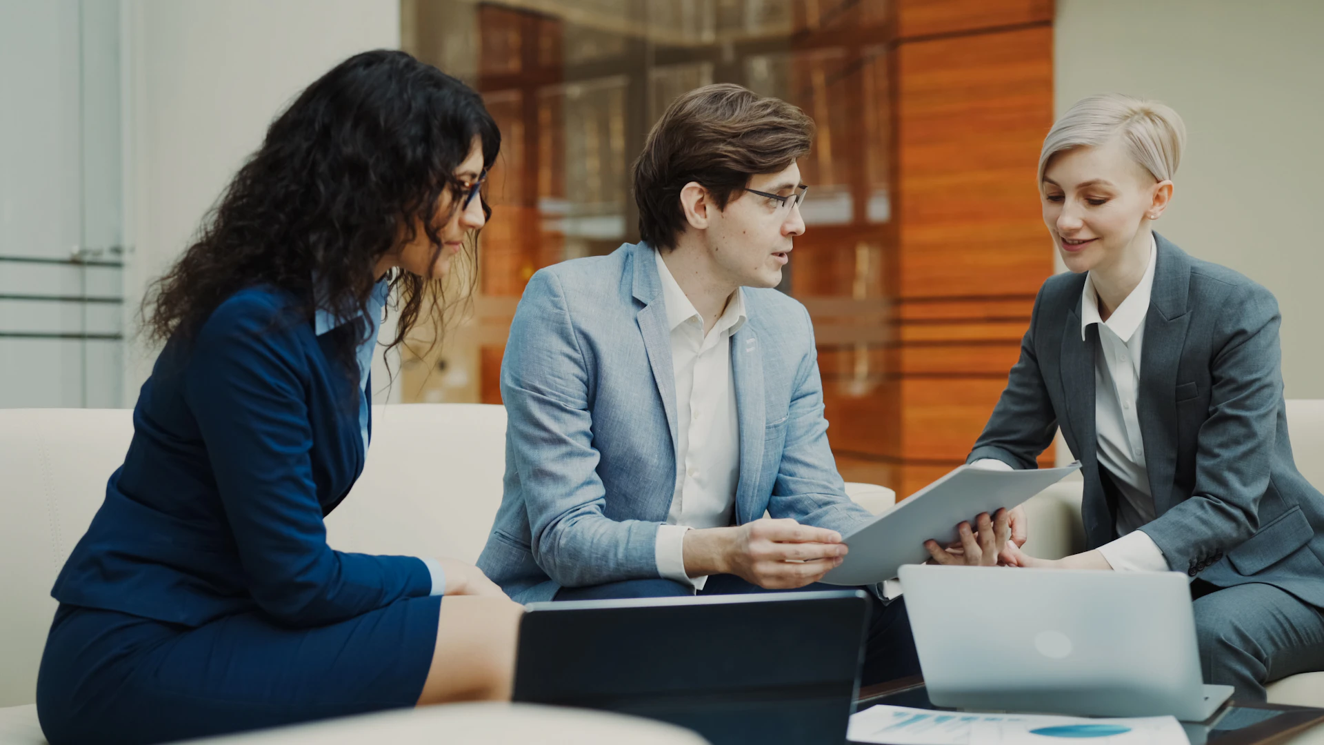 Business professionals discussing documents in a meeting