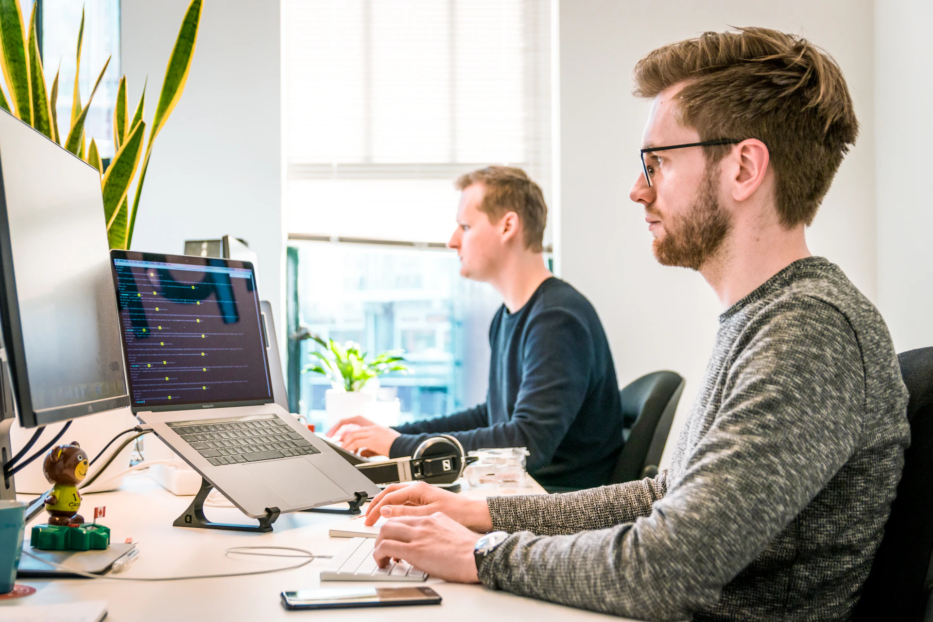 Software developers working at computer workstations