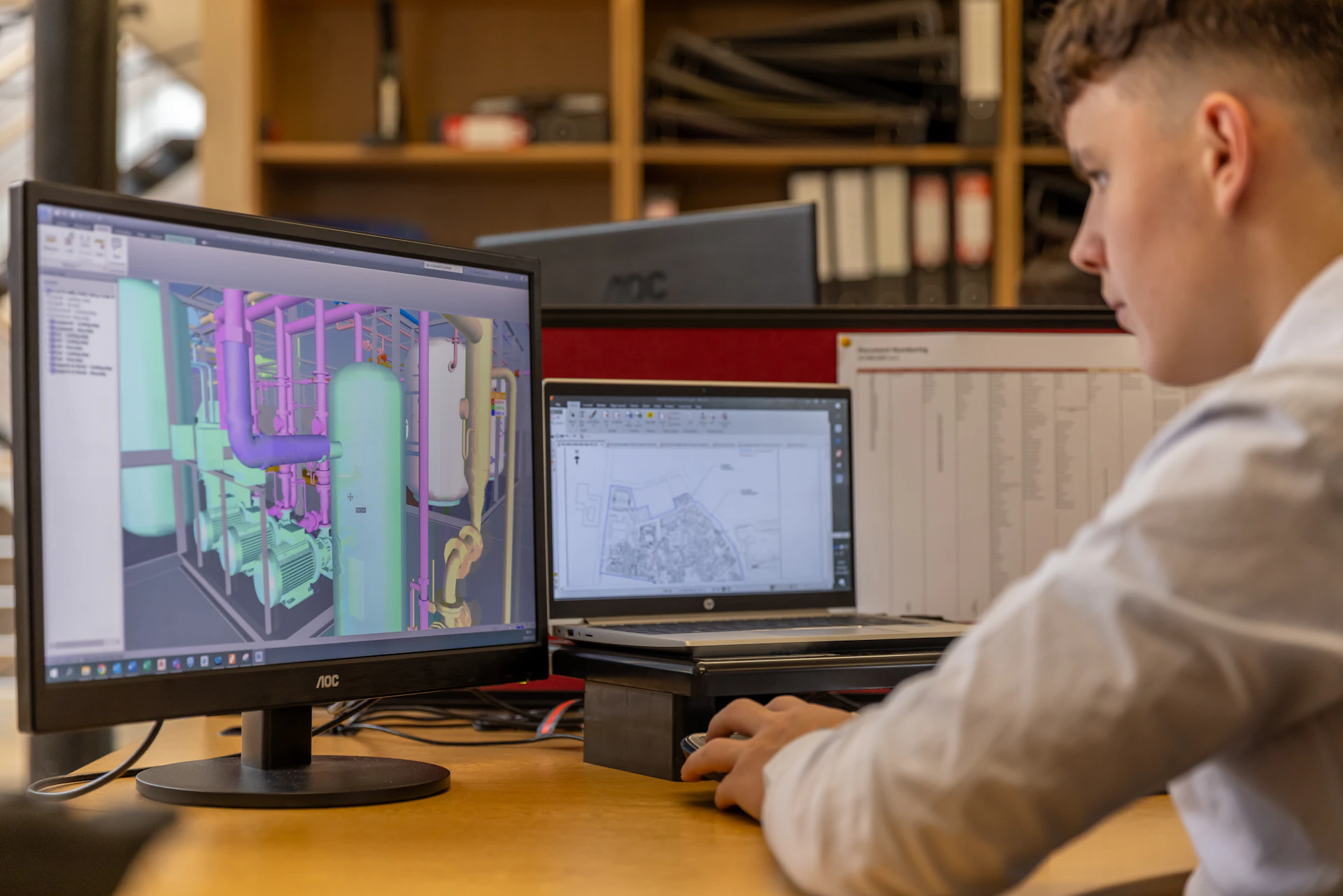 Engineer working on a design at a computer workstation