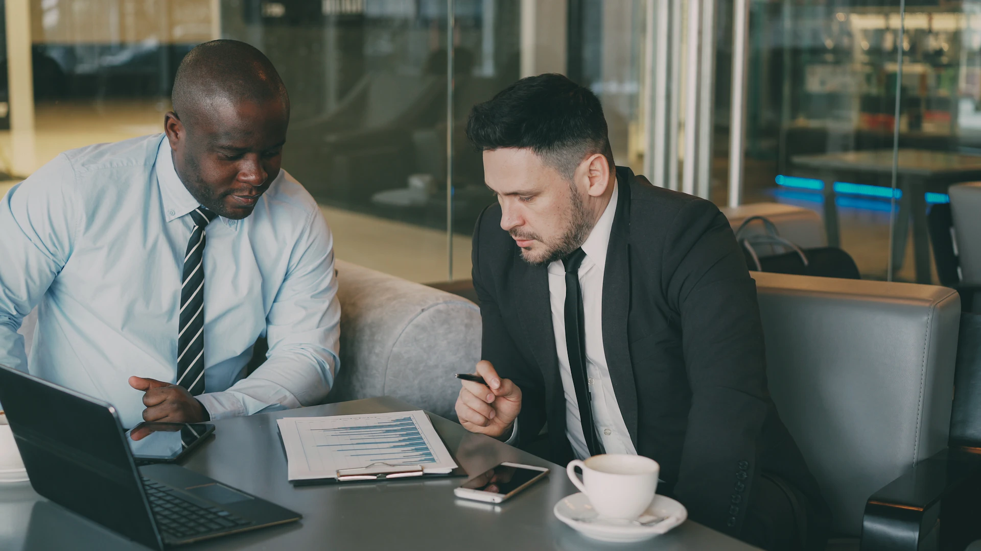 Business professionals reviewing financial charts and written notes