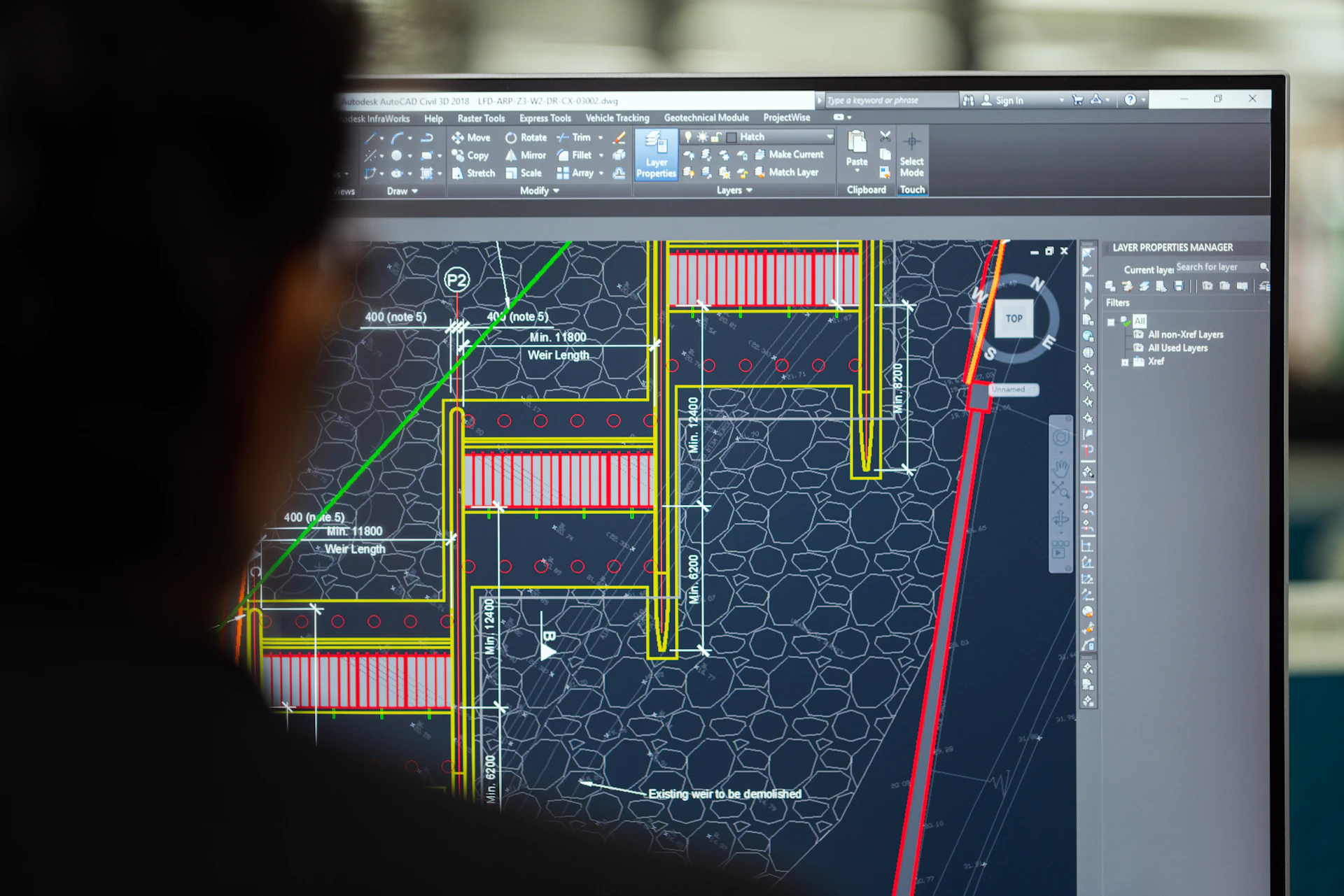 Engineer checking a technical model at a computer